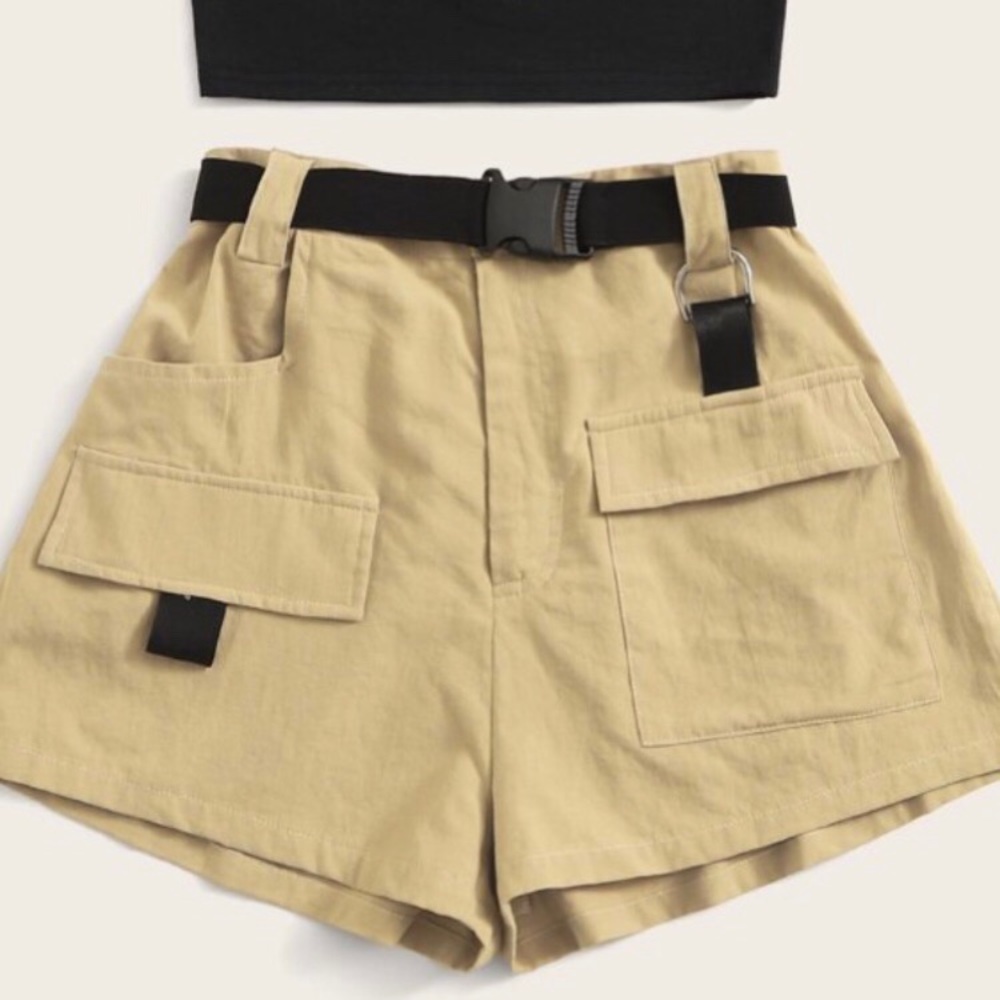 Beige cargo shorts with buckle belt.